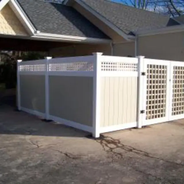 Two-tone vinyl privacy fence with a lattice top and gate, installed by TJM Yard Enhancing